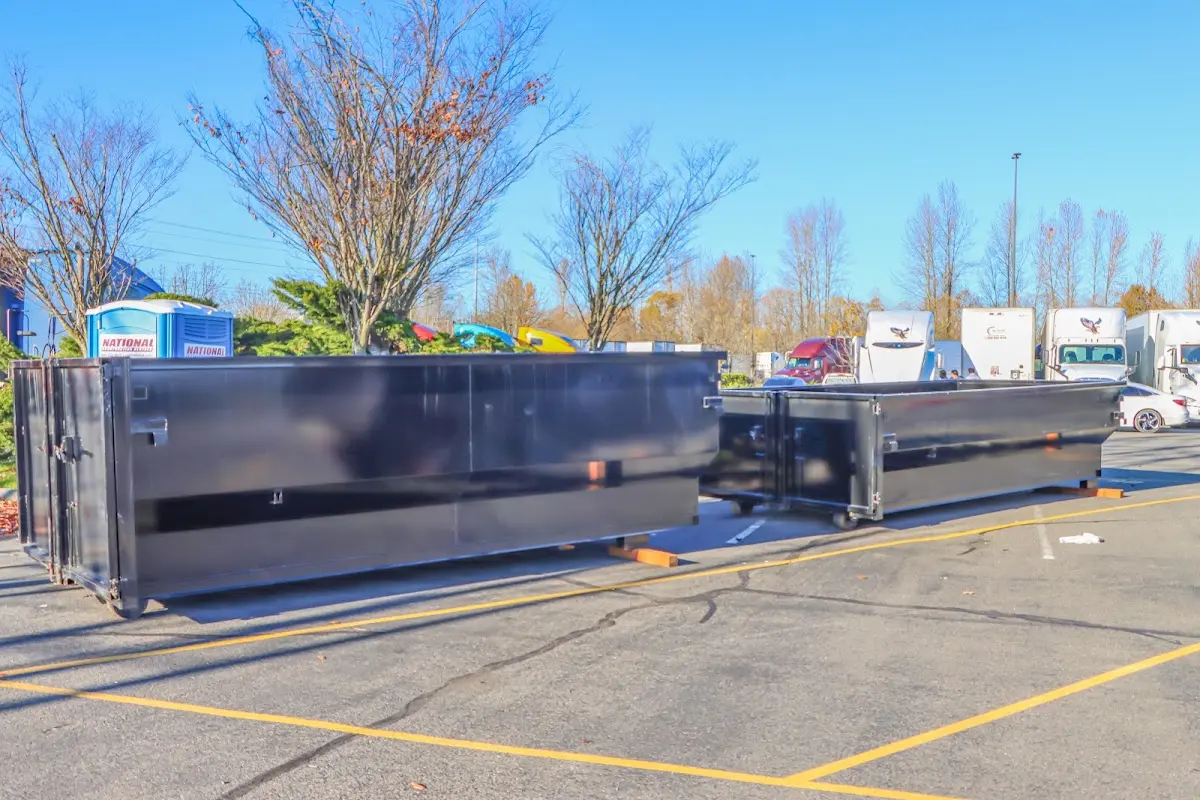 Professional dumpster rental service with roll-off container on residential driveway in South Venice